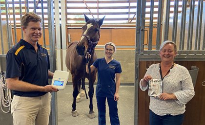 (L-R) UQ's Prof. Ben Ahern with a LAMP Genie III diagnostic machine, veterinary nurse Gabriella Doxey with horse Cartouche and veterinary researcher Lyndal Hulse holding the Hendra diagnostic sampling kit.